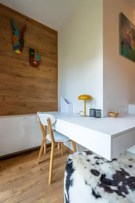 a white desk and a chair in a room at Arte Apartment in Sofia