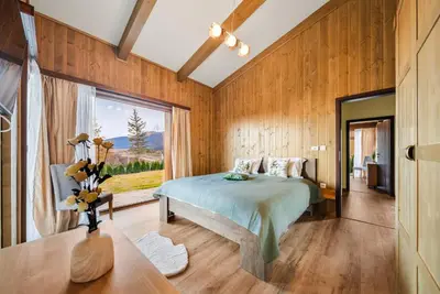 a bedroom with a bed and a large window at Luxury Mountain Villa Pirin Golf K29H02 by Top Kvartiri Ltd in Razlog