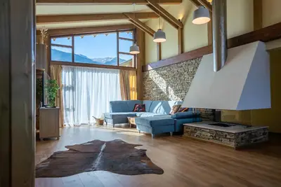 a living room with a blue couch and a fireplace at Luxury Mountain Villa Pirin Golf K29H02 by Top Kvartiri Ltd in Razlog