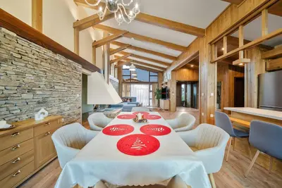 a dining room with a table with red plates on it at Luxury Mountain Villa Pirin Golf K29H02 by Top Kvartiri Ltd in Razlog