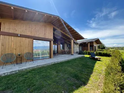 a house with a view of the yard at Pirin Golf Lux Villa for Ski & Chill by Top Kvartiri Ltd in Razlog
