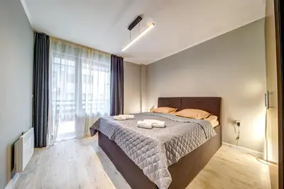 a bedroom with a bed with two towels on it at Dream View 1BD - Quick Slope Access by Flat Manager in Pamporovo