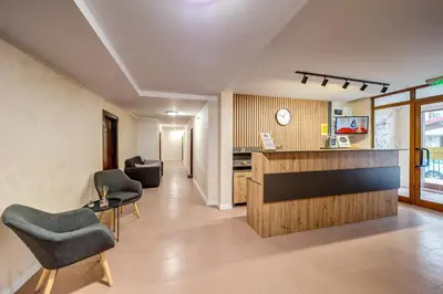 a lobby with chairs and a counter in a building at Dream View 1BD - Quick Slope Access by Flat Manager in Pamporovo
