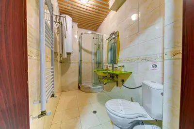 a bathroom with a toilet and a sink at Colorful Retreat - 1BD next to the slopes by Flat Manager in Pamporovo