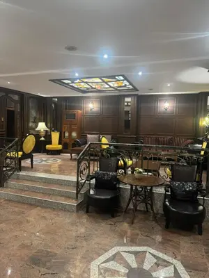 a lobby with tables and chairs and a ceiling at Комлекс Кристо in Blagoevgrad