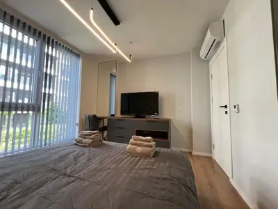 a large bedroom with a large bed and a tv at Gran Capital - Vodoley Rose Garden !Free Parking! in Sofia