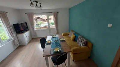 a living room with a couch and a table at Бащината Къща in Sapareva Banya
