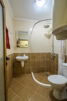 a bathroom with a toilet and a sink at Comfy & Chic Apartment , SWU , FREE Parking in Blagoevgrad