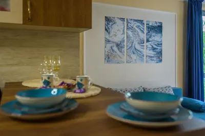 a wooden table with blue bowls on top of it at Comfy & Chic Apartment , SWU , FREE Parking in Blagoevgrad