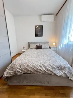 a bedroom with a large bed and a window at Giza Cozy 1BDR w WiFi near Arena 8888 and SofiaMed in Sofia