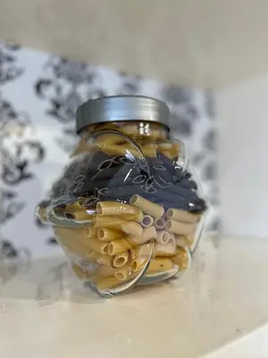 a glass jar filled with pasta sitting on a table at Sofia Harmony Apartment in Sofia