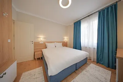 a bedroom with a large bed and a large window at Miro's Central Apartment in Sofia