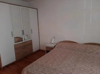 a bedroom with a bed and a dresser and a mirror at Дом Борисови in Sofia