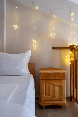 a bedroom with a bed and a nightstand with lights at Villa Veselina Loft Studios in Hisarya