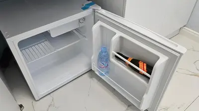 an open refrigerator with a bottle of water and markers at Urban Stay Sofia in Sofia
