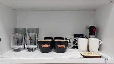 a shelf with cups and other items on it at Urban Stay Sofia in Sofia
