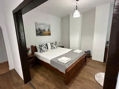 a bedroom with a bed with white sheets and pillows at TRIIBRIA Guest house in Trigrad