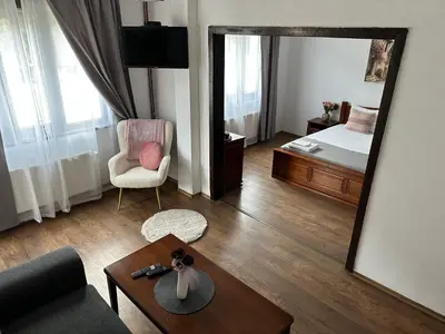 a living room with a mirror and a bed at TRIIBRIA Guest house in Trigrad