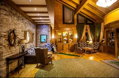 a living room filled with furniture and a brick wall at Apartment 78 by the pool in Bansko