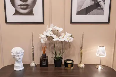 a table with vases and a bust and flowers on it at Amber Corner I Brand New Flat Top Location in Sofia