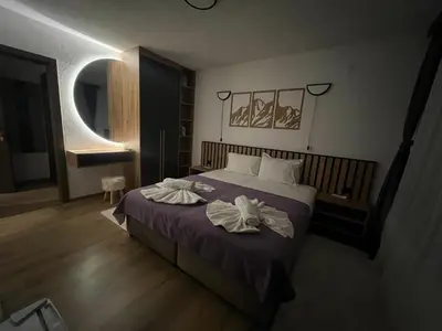 a bedroom with a bed with towels on it at Guest House Raffe in Dobrinishte