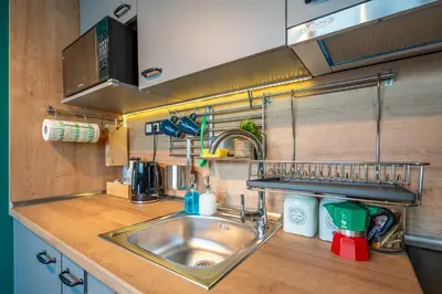 a kitchen with a stainless steel sink and a counter at Leafy Loft in Sofia