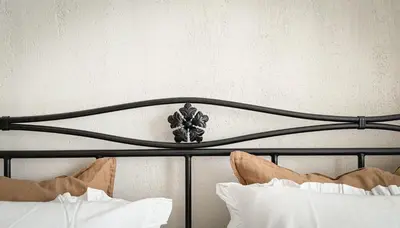 a black headboard of a bed with white pillows at Stylish Retreat in Sofia in Sofia