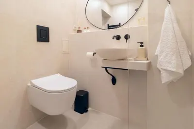 a bathroom with a toilet and a sink and a mirror at Stylish Retreat in Sofia in Sofia