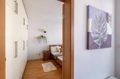 a hallway leading to a bedroom with a bed at Spacious 1 bedroom apartment in a lively center in Sofia
