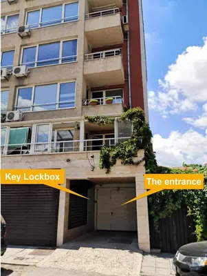 an apartment building with a key lockbox and the entrance at Spacious 1 bedroom apartment in a lively center in Sofia
