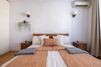 a bedroom with a large bed with two night stands at Spacious 1 bedroom apartment in a lively center in Sofia