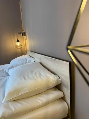 a bed with two pillows on it in a room at VeliApartmets in Velingrad