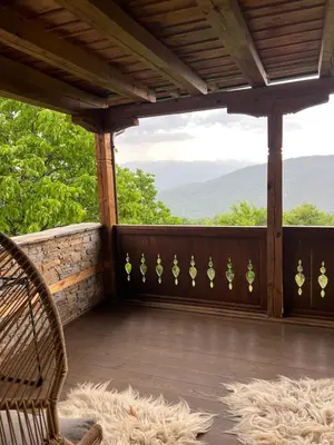 a screened porch with a view of the mountains at Къща в Родопа планина in Leshten