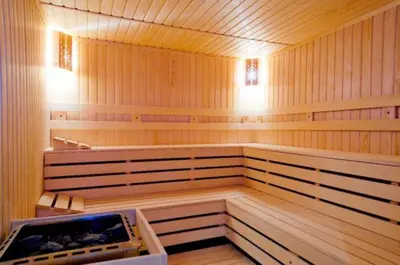 a large empty sauna with wooden walls and wooden floors at Ski Retreat Spa Pool and Mountain Views in Bansko