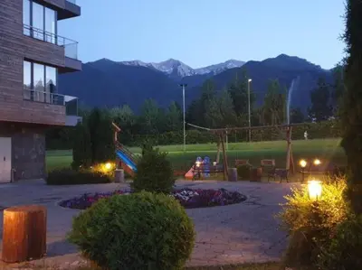 a garden with a playground in a park at night at Ski Retreat Spa Pool and Mountain Views in Bansko