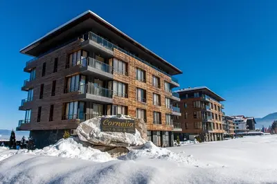 a building with a sign in the snow at Ski Retreat Spa Pool and Mountain Views in Bansko