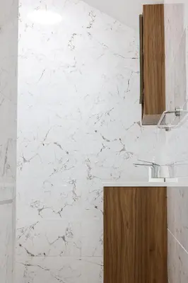 a bathroom with a sink and a white marble wall at Free parking, Close to Subway, Central location in Sofia