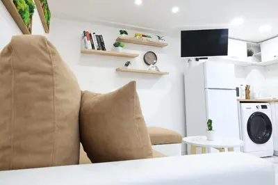 a living room with a chair and a microwave at Free parking, Close to Subway, Central location in Sofia