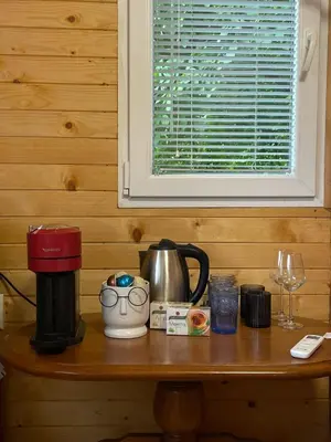 a table with a coffee maker and a coffee pot at Kъщичка в полите на планина Витоша с коне и животни in Sofia