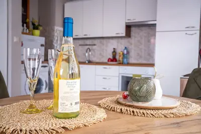 a bottle of wine sitting on top of a table at Center and Old Town Apartment in Plovdiv