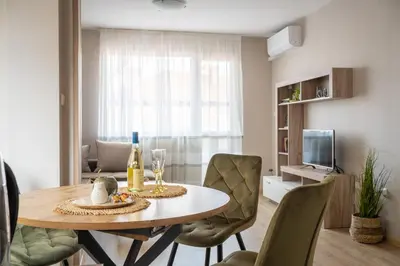 a living room with a dining room table and chairs at Center and Old Town Apartment in Plovdiv