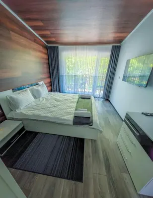 a small bedroom with a bed and a window at Апартамент Петя 2 in Velingrad