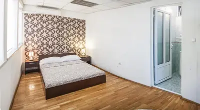 a bedroom with a bed and a large window at Sofia Central Guest Rooms in Sofia