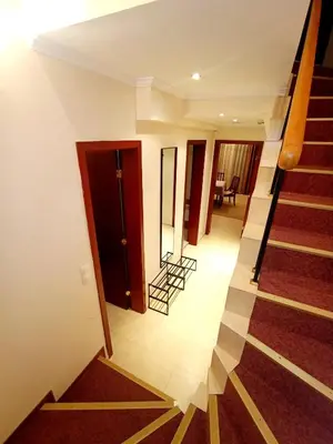 a view of a hallway with stairs in a house at 3 Rooms Apartment next to the Ski lift in Bansko
