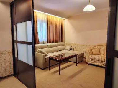 a living room with a couch and a table at 3 Rooms Apartment next to the Ski lift in Bansko