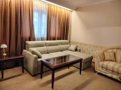 a living room with a couch and a coffee table at 3 Rooms Apartment next to the Ski lift in Bansko