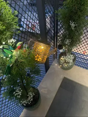 a balcony with three potted plants and a light at The Modern Nest Apartment with FREE Underground Parking in Plovdiv