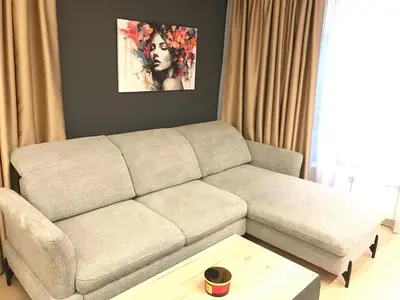 a living room with a couch and a table at The Modern Nest Apartment with FREE Underground Parking in Plovdiv