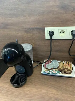 a coffee maker sitting next to a plate of food at The Modern Nest Apartment with FREE Underground Parking in Plovdiv