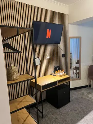 an office with a desk with a n sign on the wall at Kolev Apartment in Sofia
